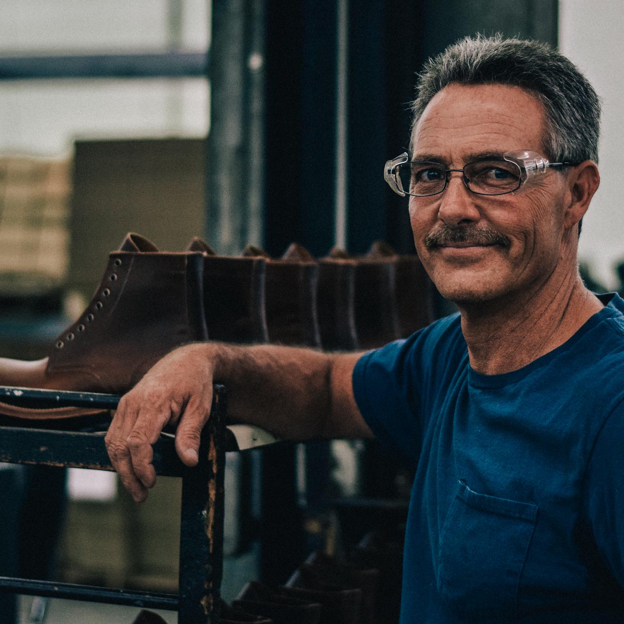 A proud bootmaker at an Oak Street Bootmakers Factory