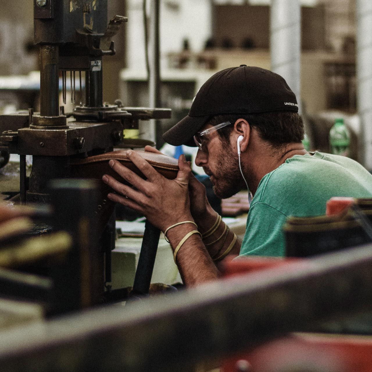 A young bootmaker attaches a heel to a Trench Boot